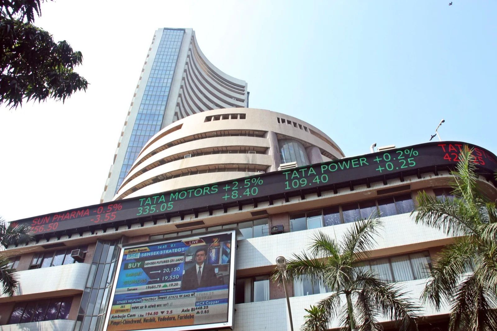 A trading floor display board showing IPO subscription figures and price movements at an Indian stock exchange