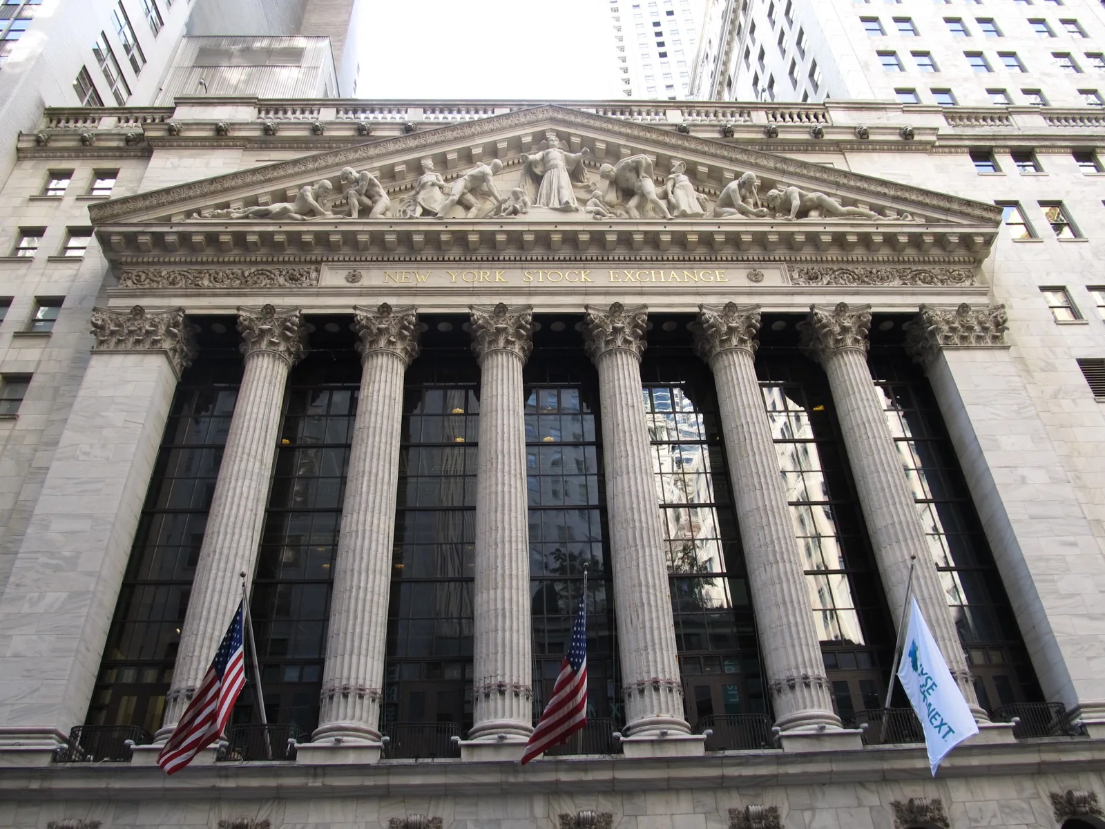 A stock exchange trading floor display showing ticker symbols and price movements, representing companies going public